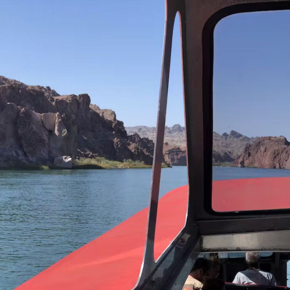 a body of water with a mountain in the background