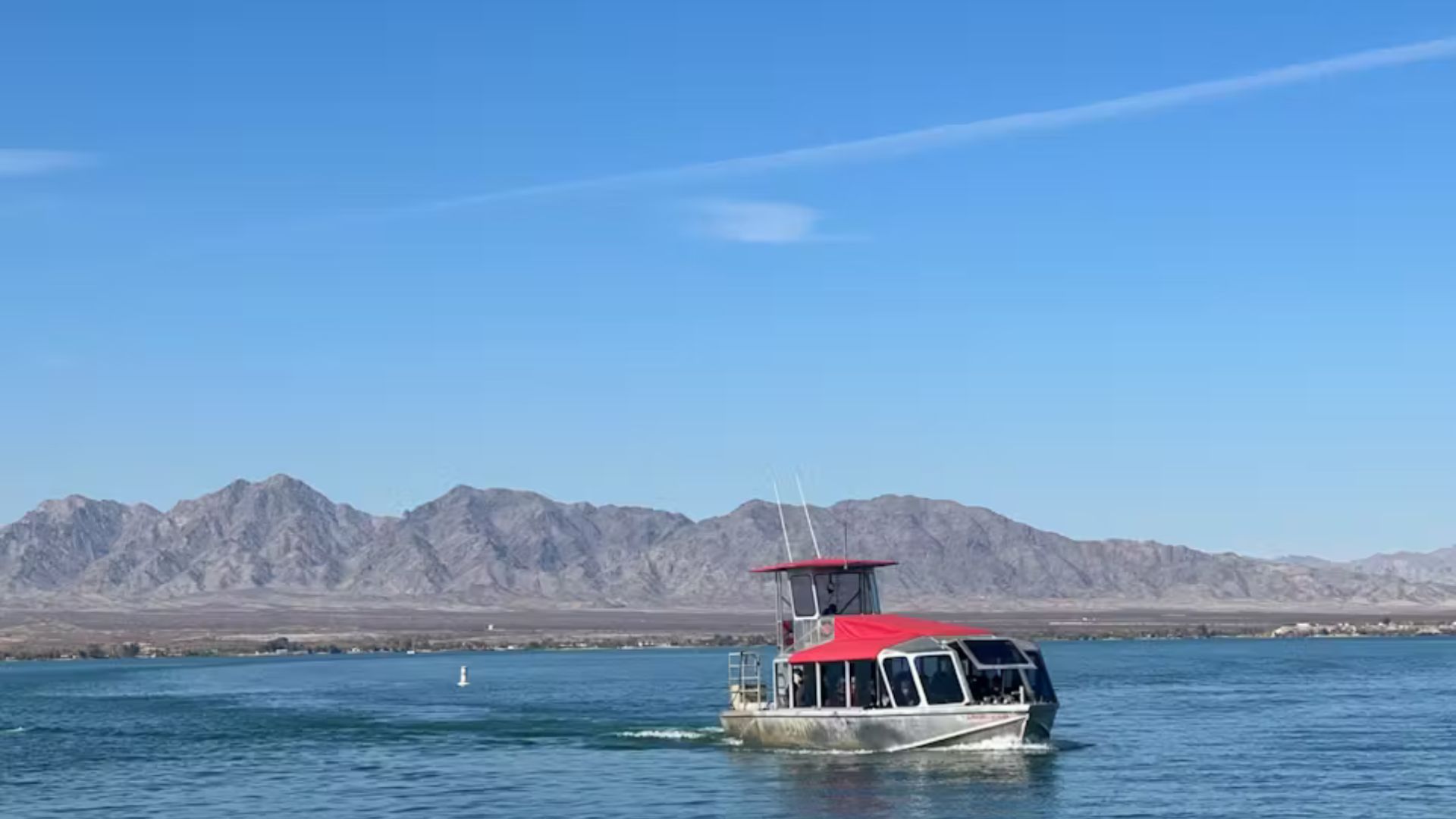 Four Tips for a Safe and Exciting Jet Boat Tour a small boat in a body of water with a mountain in the background