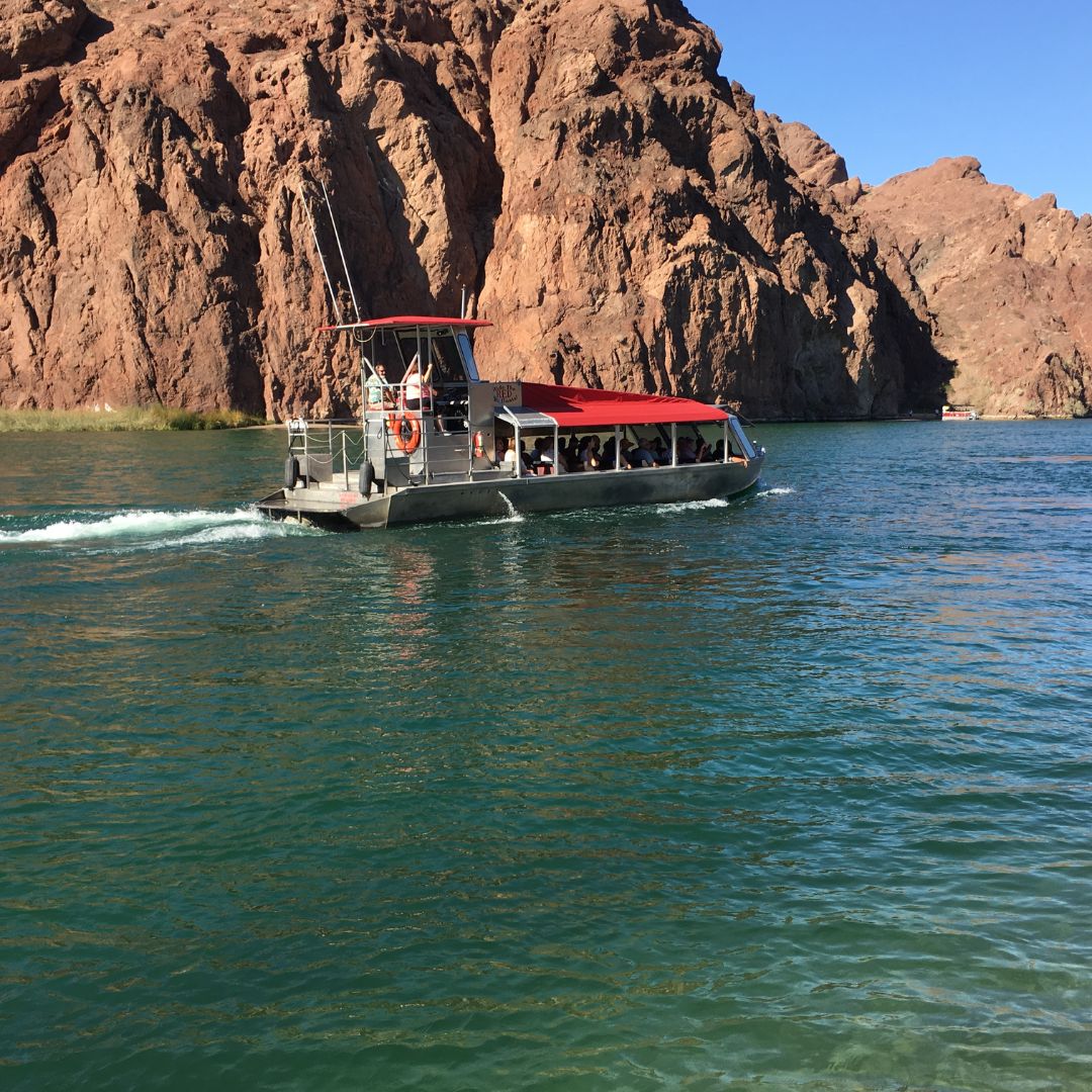 a boat on a body of water with a mountain in the background